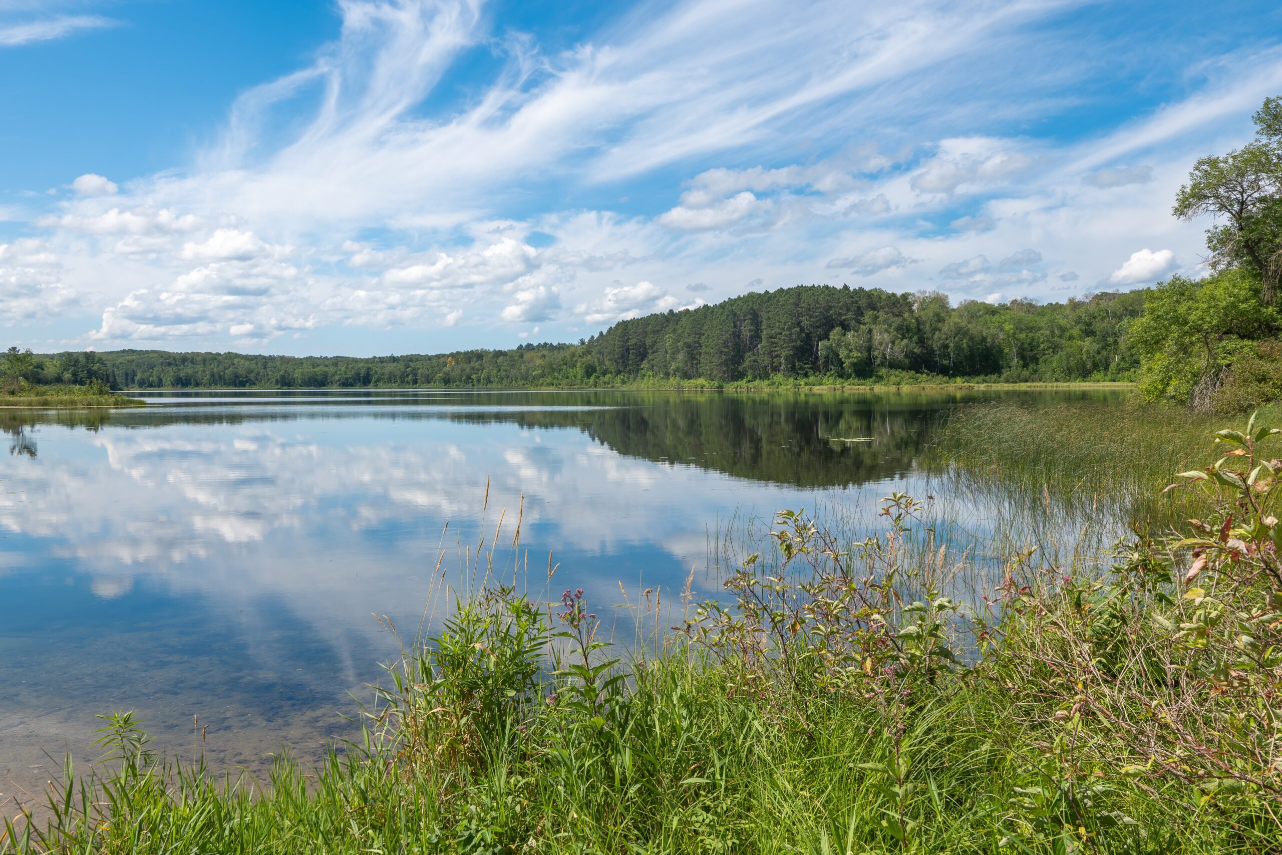 Idyllic,Landscape,Of,Calm,Water,And,Reflection,Of,Blue,Sky